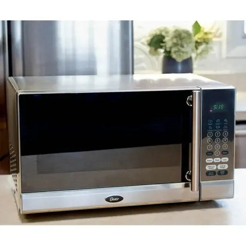 Wholesale-Oster OGYK0703 Microwave Stainless Steel Front 0.7 CF-Electro Vision Inc